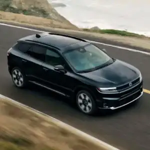2026 Honda Prologue Elite Raven Black driving next to the ocean