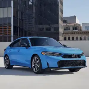 2026 Honda Civic Hatchback Sport Touring Hybrid Boost Blue Pearl in a city