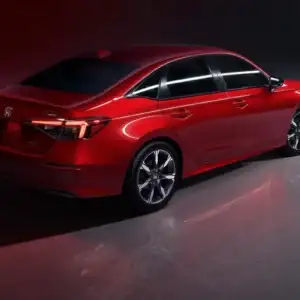 2026 Honda Civic Sedan Sport Touring Hybrid Rallye Red rear and side view