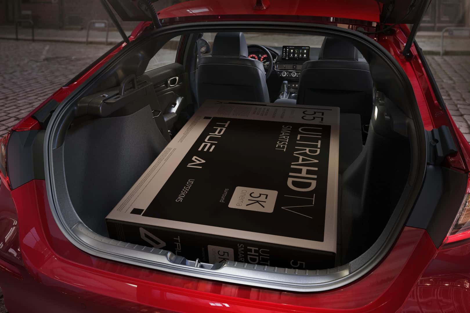 The Spacious Cargo Hold, With An Large TV Place Inside For Reference, Of The Roomy And Budget Friendly Honda Civic Hatchback Sport Touring