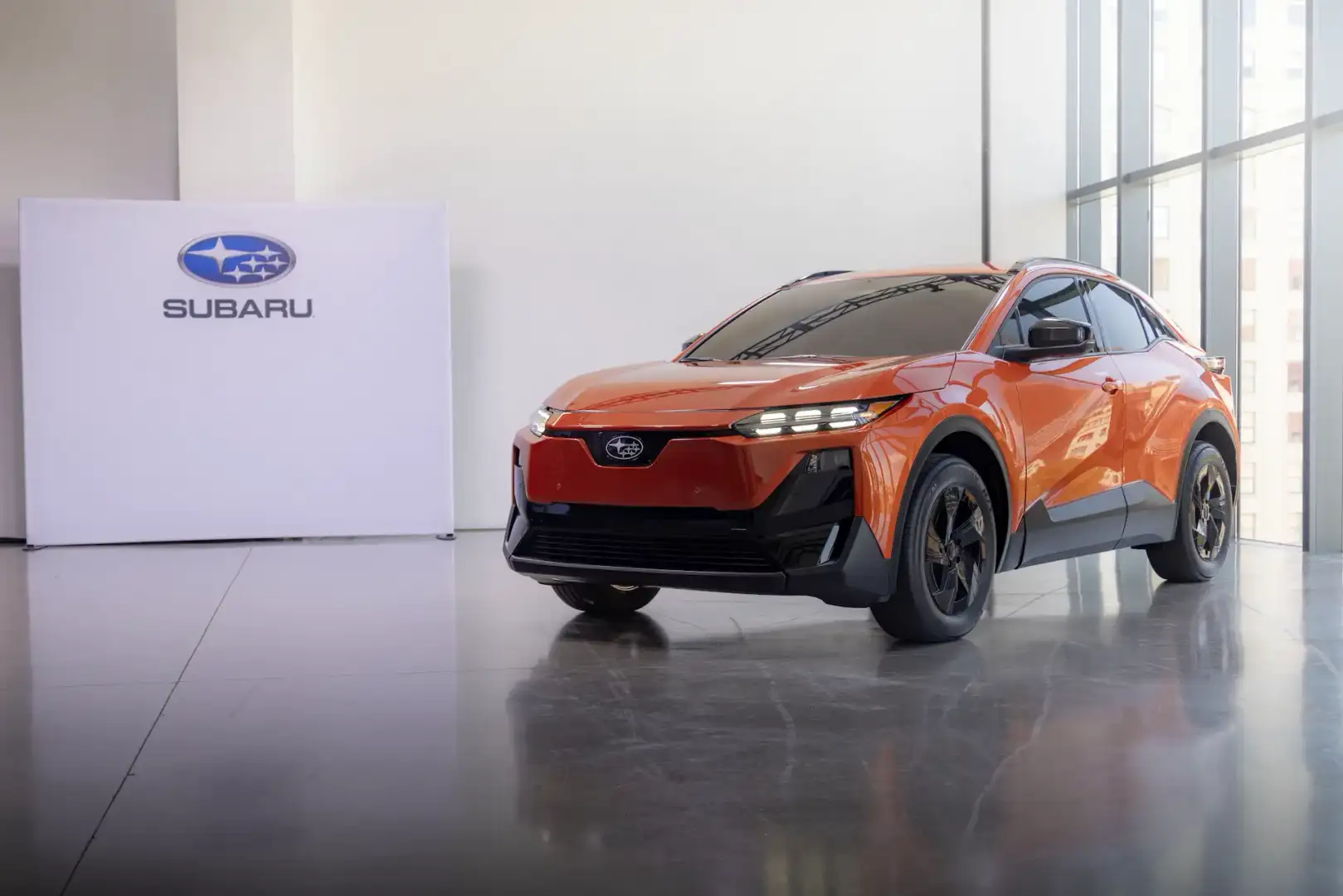 Orange Subaru Uncharted parked in a showroom
