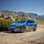 Blue 2026 Subaru Trailseeker driving of road on a dirt road
