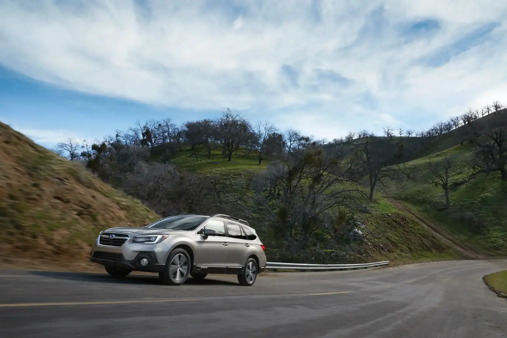Subaru Outback driving on a winding mountain road
