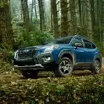 Blue Subaru Forester Wilderness parked off road in the woods