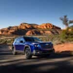 The Award Winning 2026 Subaru Outback Racing On The Highways Past The Red Dirt Hills And Greenery