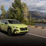 The Affordable And Efficient 2026 Subaru Crosstrek Hybrid Driving Past Beautiful Scenery