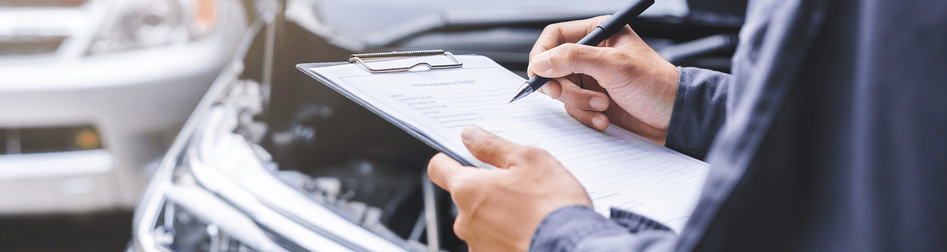 Closeup of a service technician's clipboard as they go down a checklist while checking a vehicle in the service center.