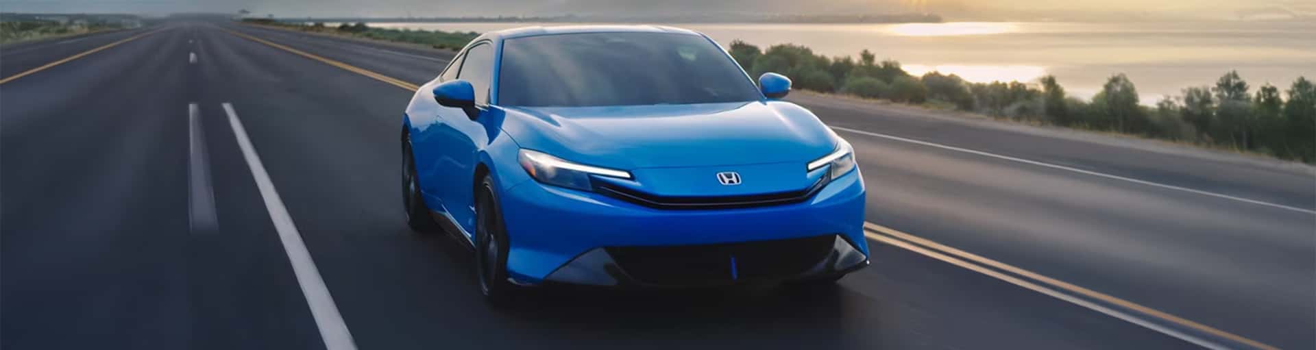 A blue Honda Prelude hybrid sports coupe on the road