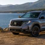 A Honda Passport TrailSport parked near a scenic lake.