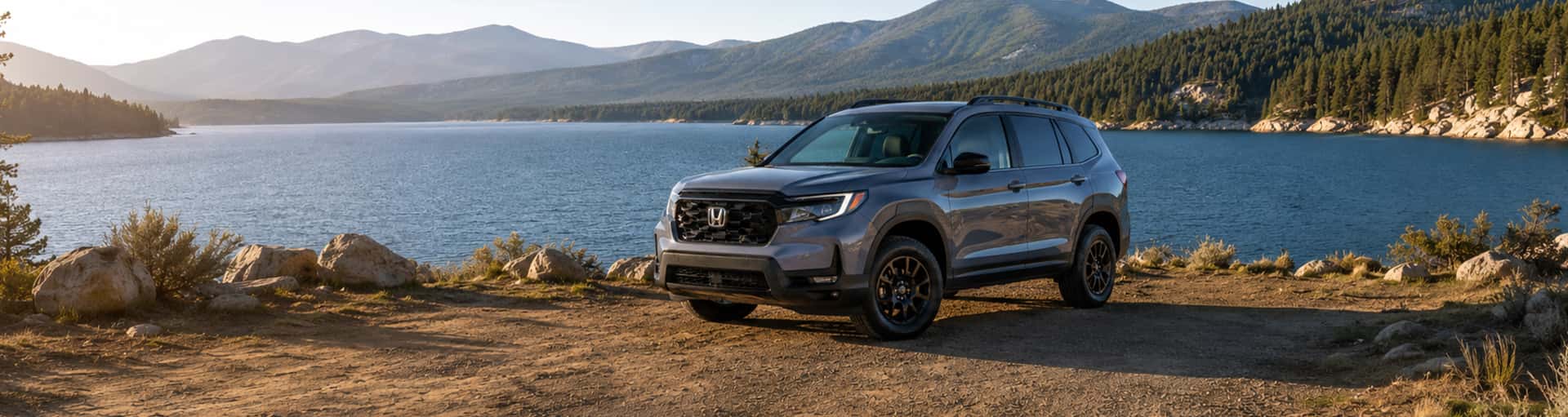 A Honda Passport TrailSport parked near a scenic lake.