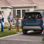 A family packing into their Toyota RAV4 parked in their driveway.