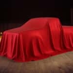 A Toyota truck hidden under red covers