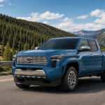 A Toyota Tacoma Limited pickup truck in Heritage Blue on a road.