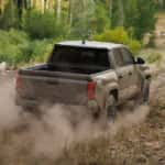 A Toyota Tacoma driving on an off-road dirt trail.