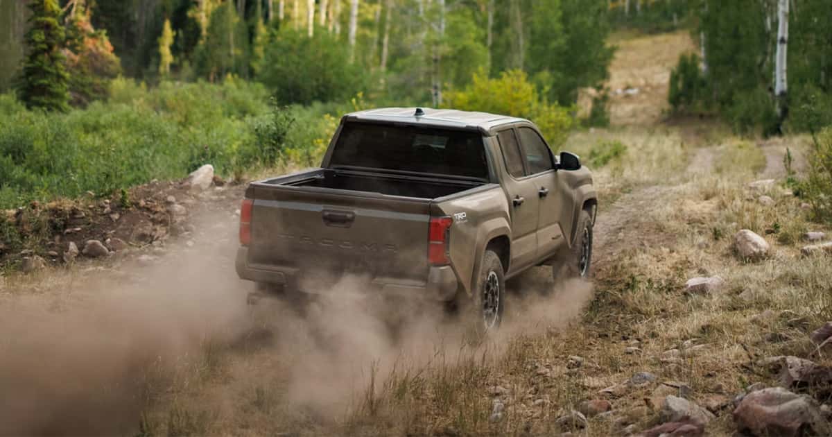 A Toyota Tacoma driving on an off-road dirt trail.