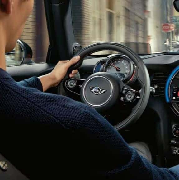 Person driving with steering wheel