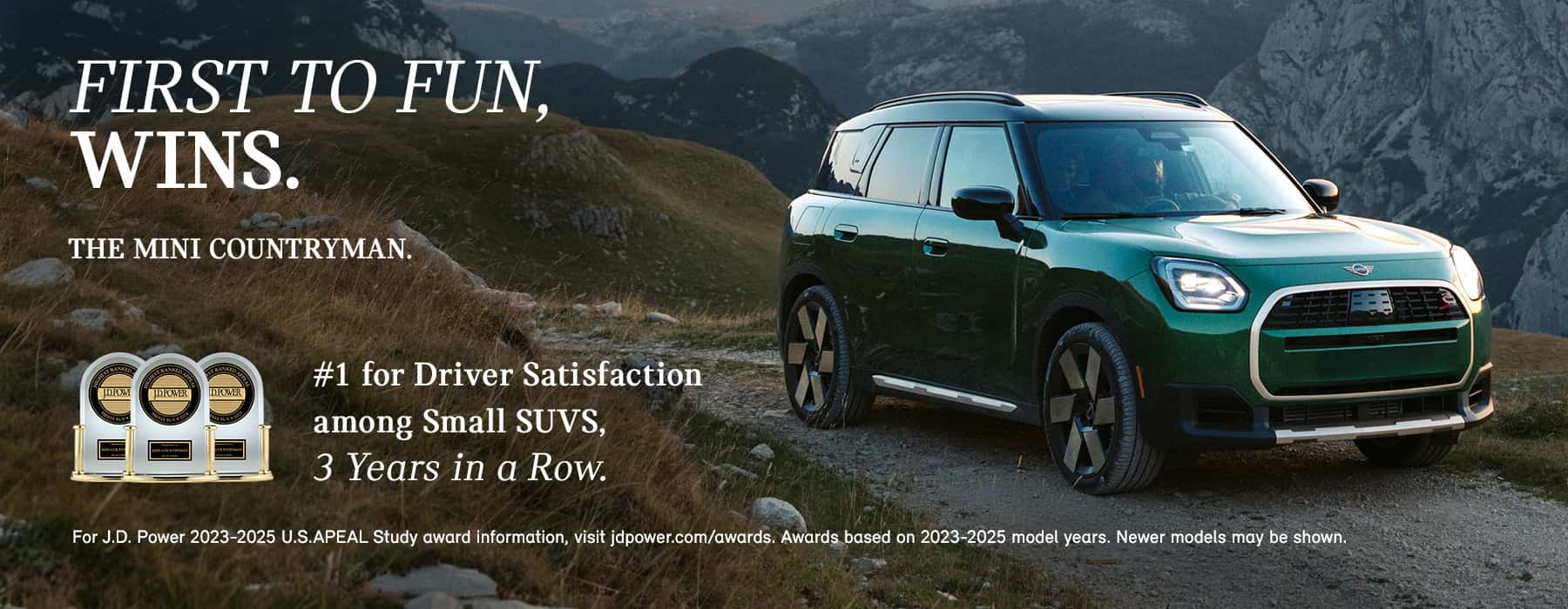 Green MINI Countryman on top of a hill.