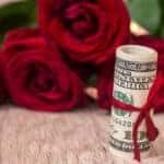 beautiful roses with money on desk