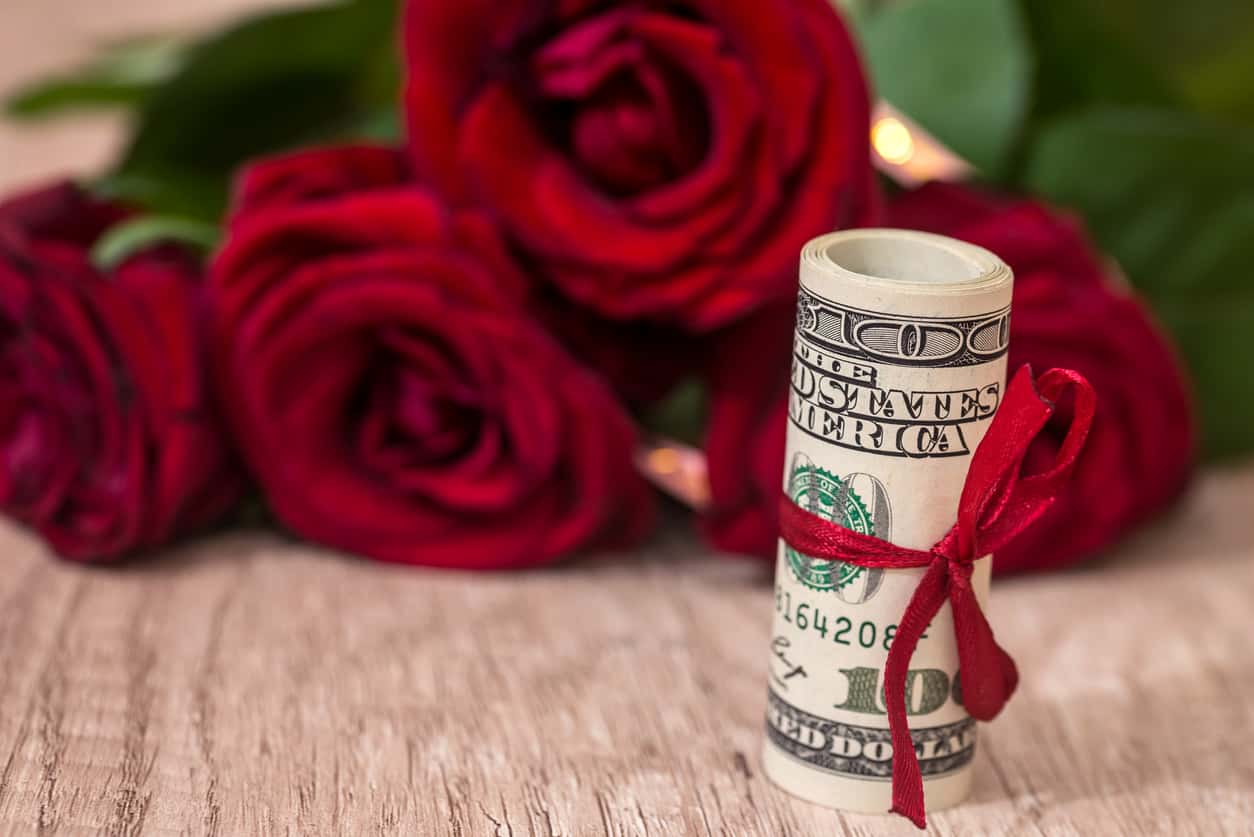 beautiful roses with money on desk
