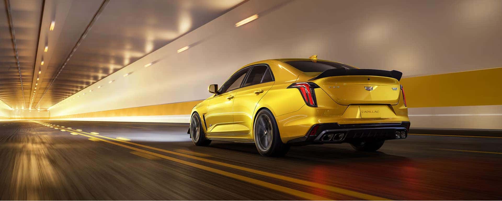 Yellow Cadillac Sedan driving through a tunnel