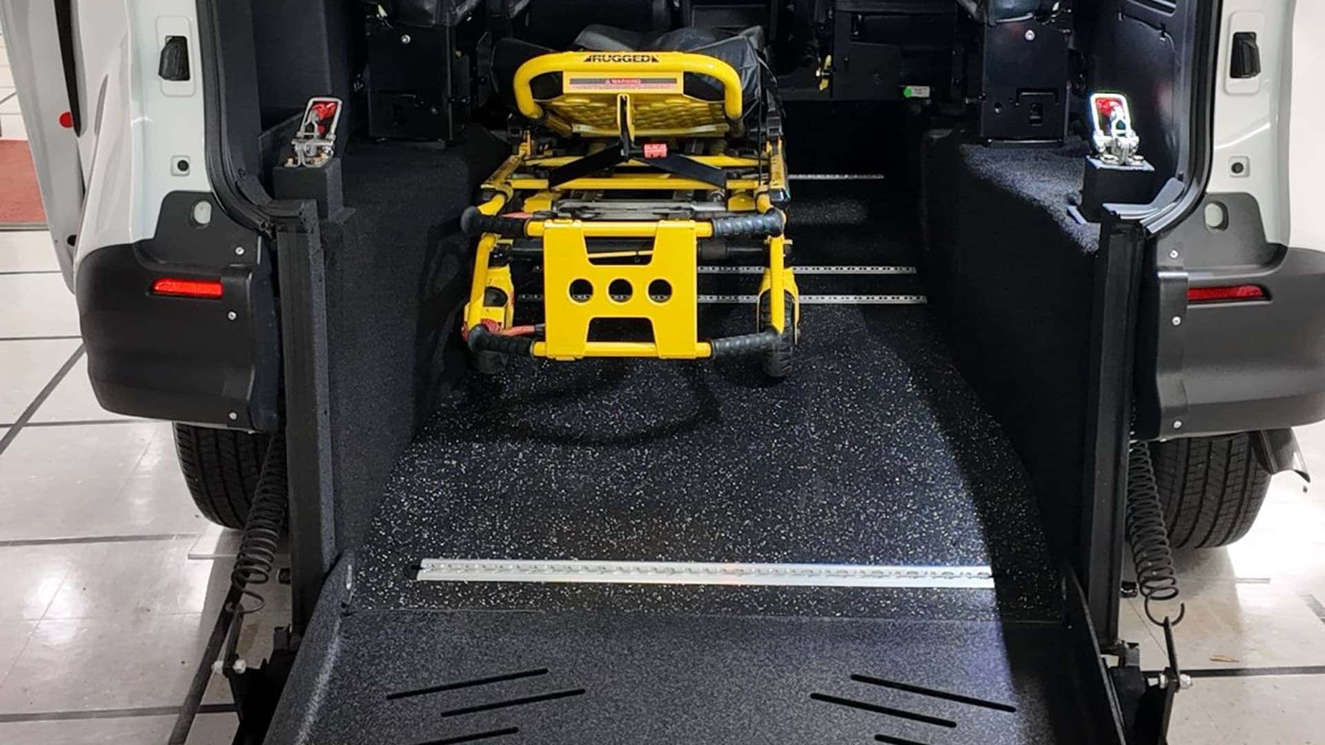 loading gurney into back of accessible vehicle