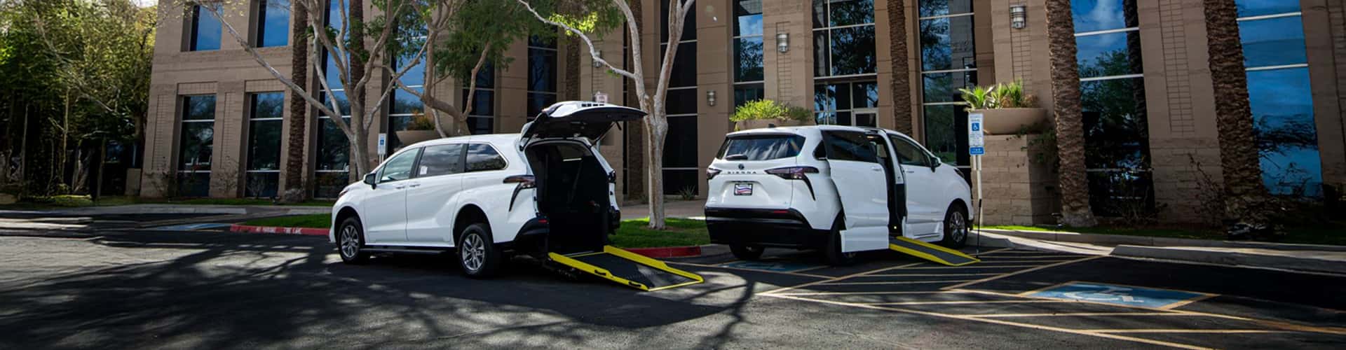 two white accessible vans parked