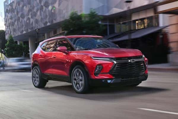 Red Chevrolet Blazer driving on a street mobile