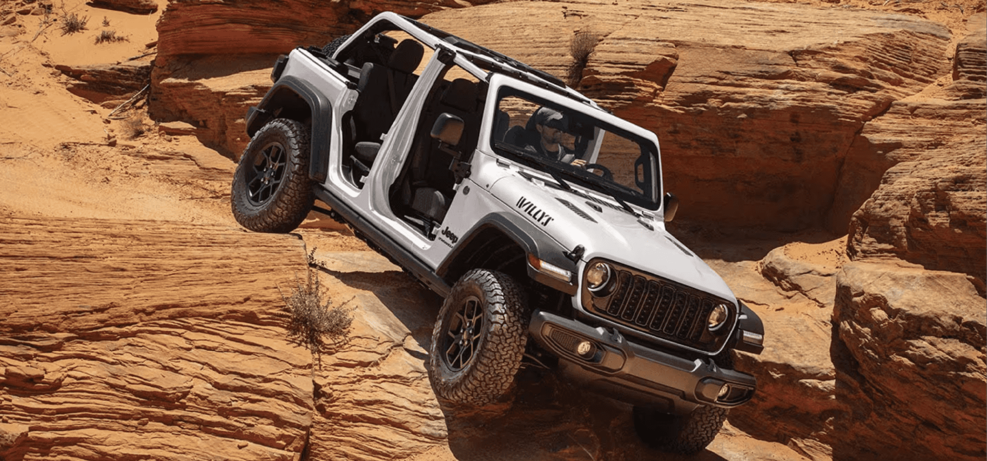 The 2026 Jeep Wrangler cruising a rocky terrain