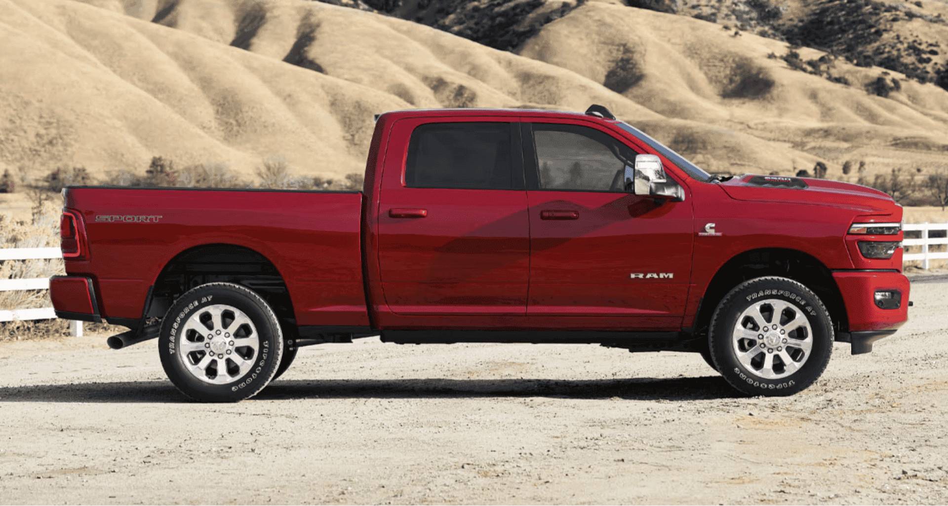 A 2026 Ram 2500 in Molten Red Pearl parked on a ranch