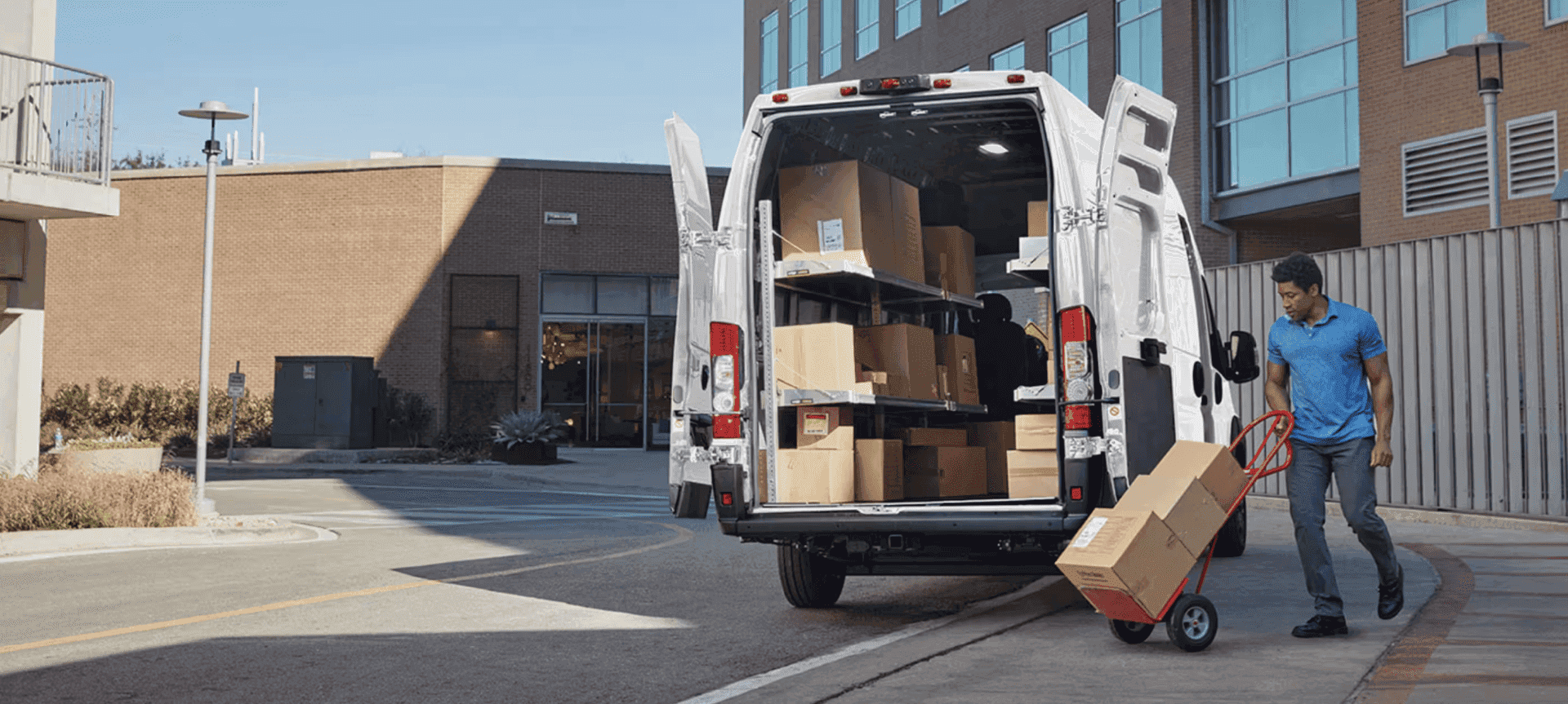 Man loading boxes into a 2026 Ram ProMaster