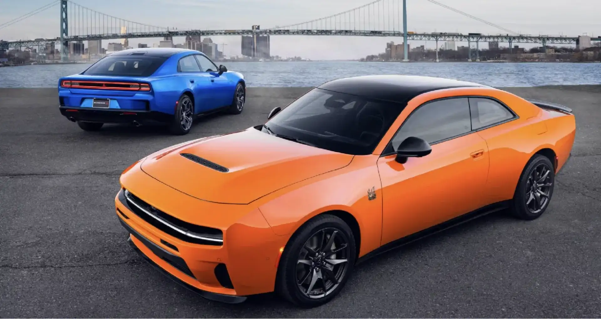 2026 Dodge Charger in Peel Out and Bluedicrous Exterior parked near a city bridge