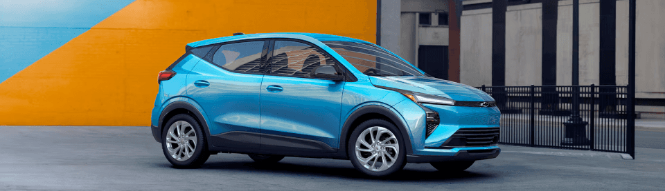 Chevy Bolt EV driving through a modern neighborhood