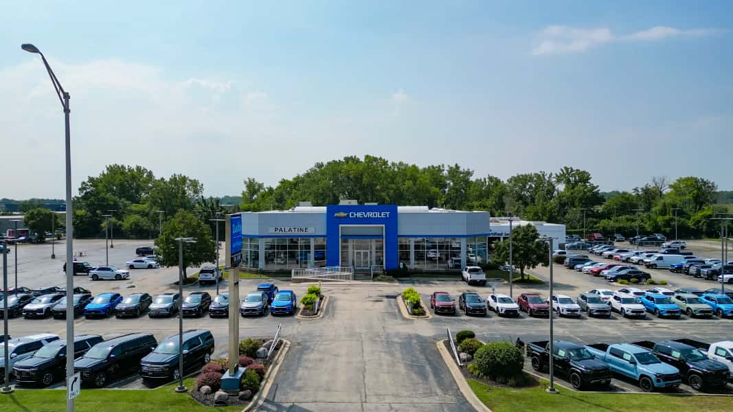 Elevated view of the Napleton Palatine Chevy dealership on Lake Cook Road, showing the Chevrolet showroom and rows of new vehicles on the lot
