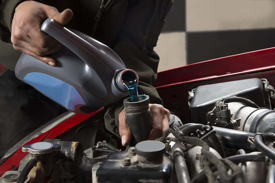 Mazda service technician inspecting engine coolant system at Napleton's Oak Lawn Mazda