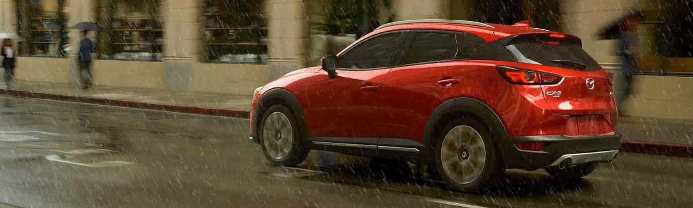 Mazda SUV driving confidently in wet winter conditions