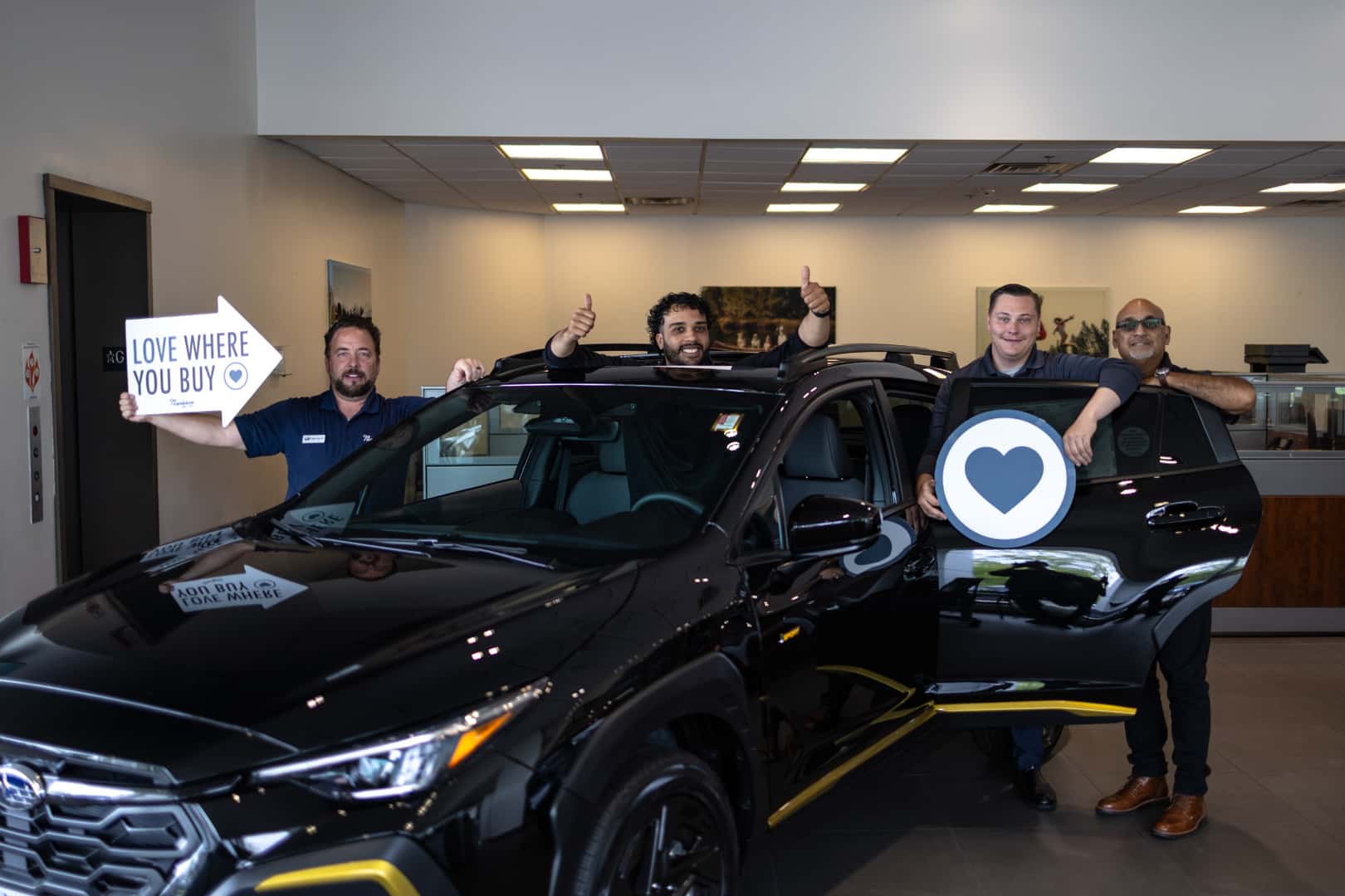 A Napleton's Schaumburg Subaru team member walking a customer through a vehicle.