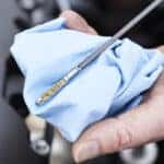 Close-Up Of Man Checking Car Engine Oil Level On Dipstick
