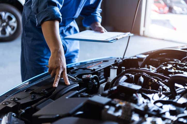 Mechanic inspecting car