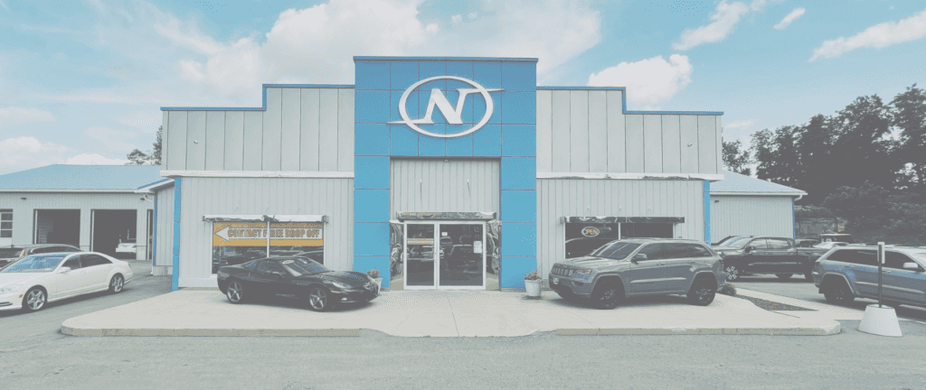 Exterior of Car Dealership with large N on the front