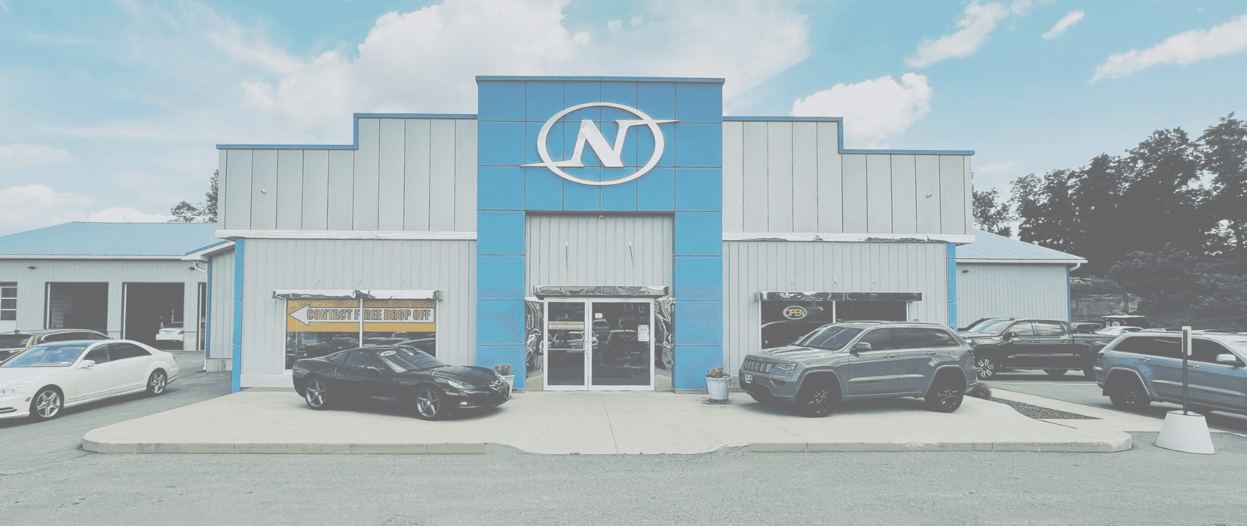 Exterior of Car Dealership with large N on the front