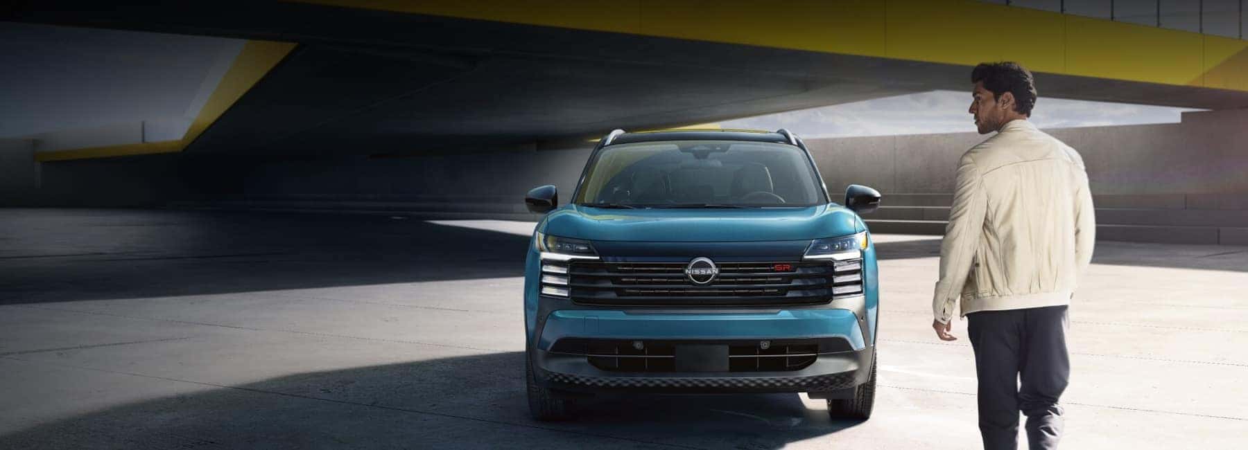 man-walking-toward-2025-Nissan-Kicks-in-rooftop-parking