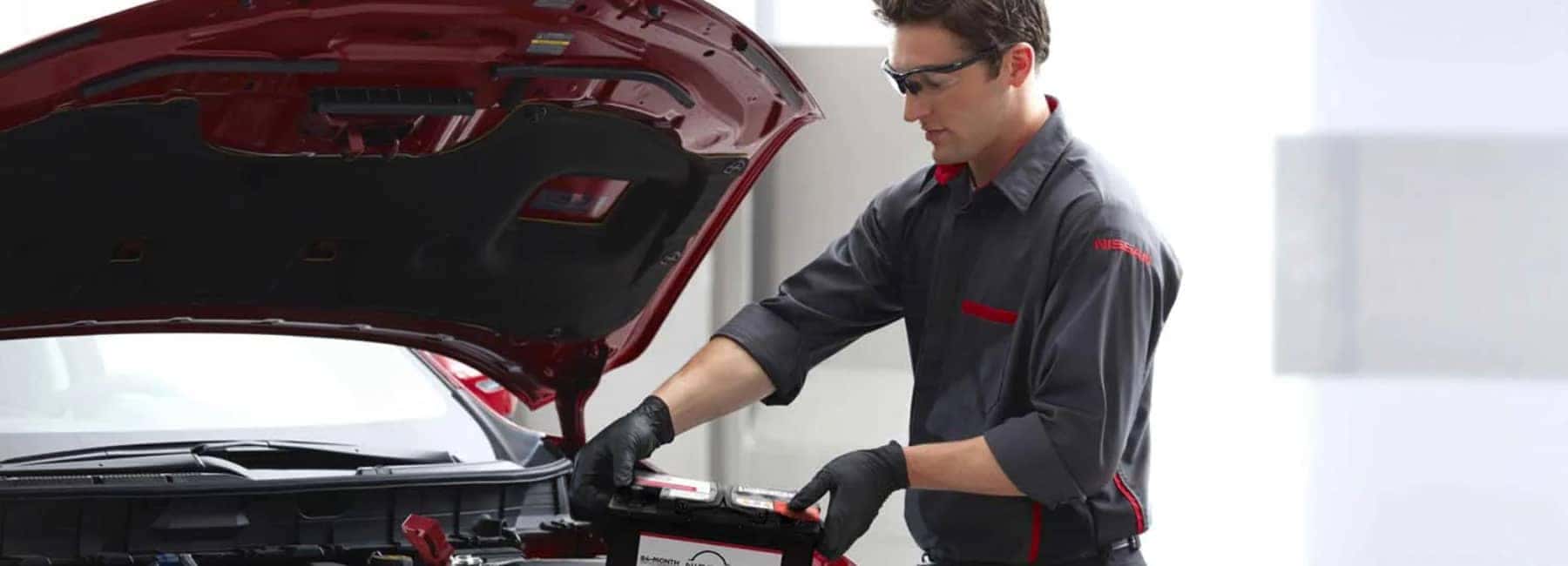 nissan-technician-replacing-a-battery
