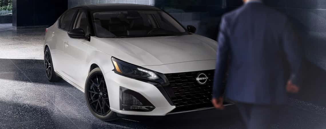 Head on view of Nissan sedan in shadows