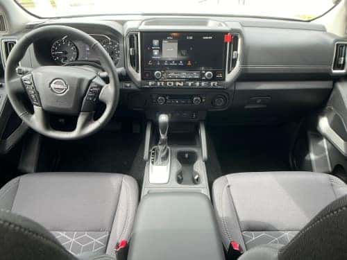 2025 Nissan Frontier interior view of front seating area and dash