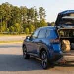 2026 Nissan Rogue rear liftgate open with school bags loaded in a Buford, GA parking lot on a late-summer afternoon