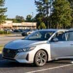 2026 Nissan Sentra parked on a Gwinnett County suburban road with a teen driver and parent