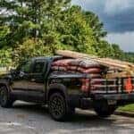 2026 Nissan Frontier with loaded bed of mulch bags and lumber on a north Georgia residential street