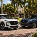 2026.5 Nissan Rogue S and SV parked with houses and palm trees in background