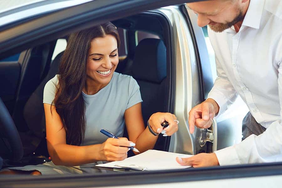 woman signing paperwork