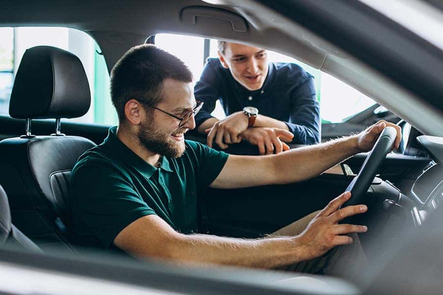 man sitting in the drivers seat of a car